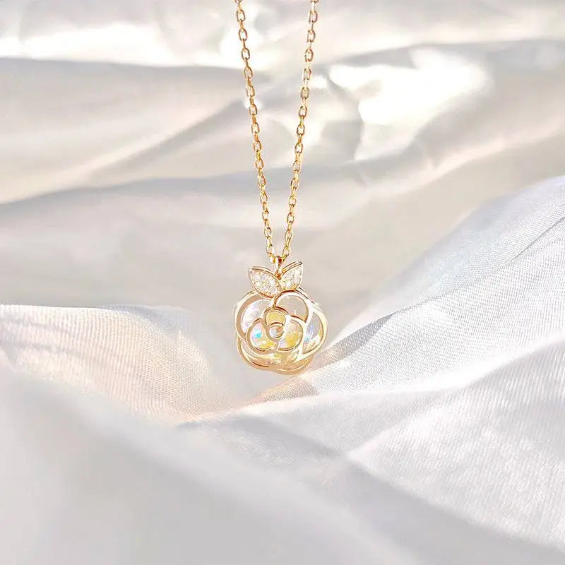 A delicate gold-toned camellia advanced design silver rose necklace with a rose pendant featuring clear gemstones