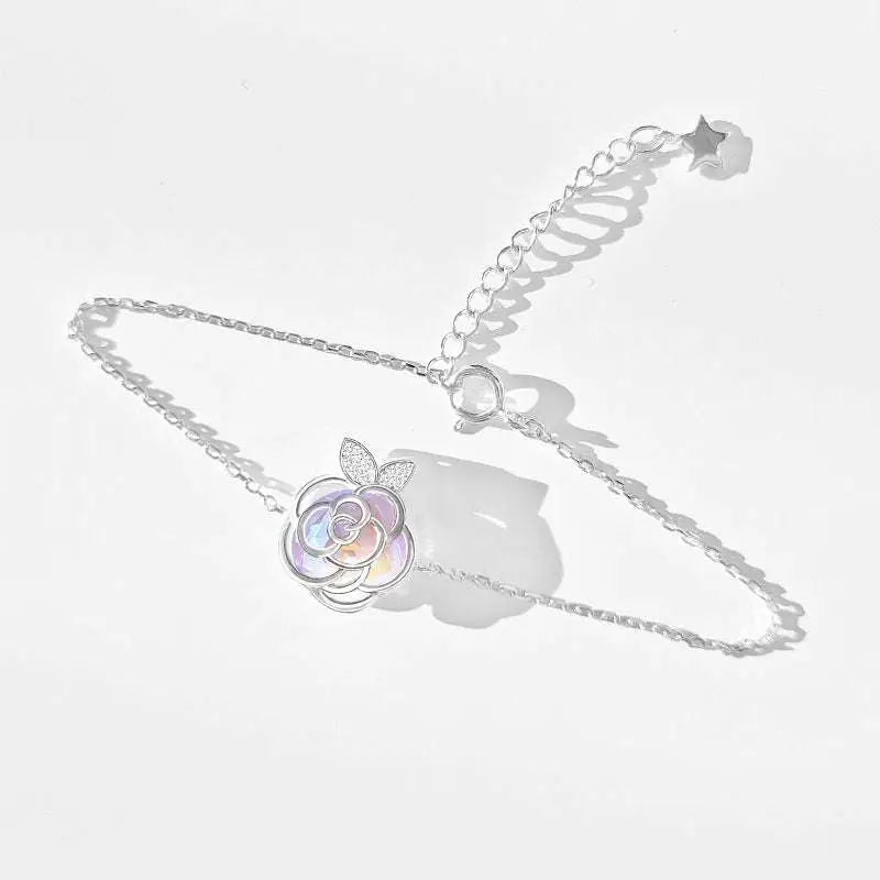 Silver rose charm bracelet with iridescent petals and star-shaped extender chain from camellia advanced design silver rose necklace