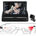 Black car seat baby monitor display with small camera showing baby in safety harness on monitor display