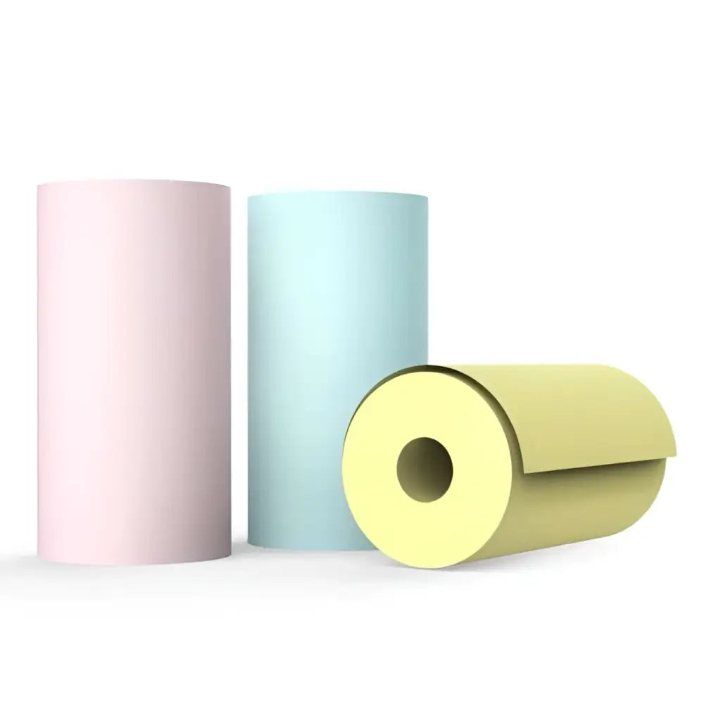 Three cylindrical rolls of pastel pink, light blue, and pale yellow paper for cat ear mini printer portable bluetooth labeler