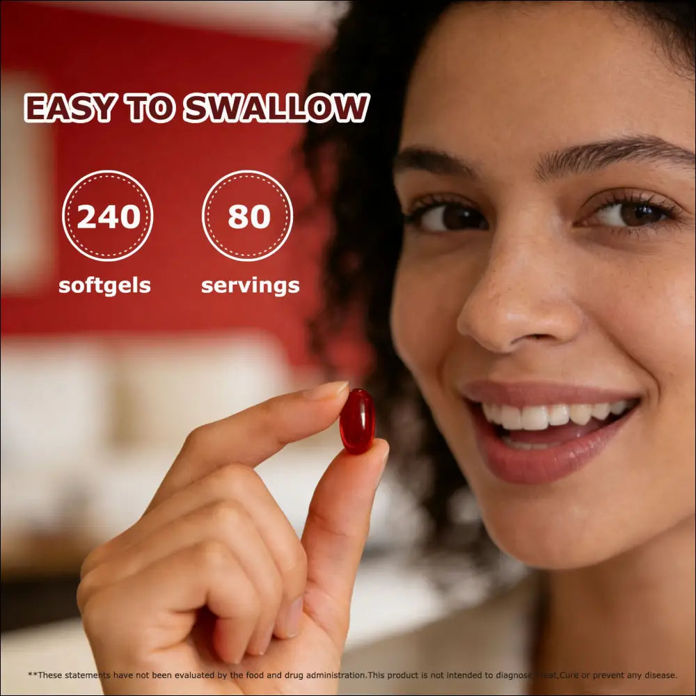 A glossy red cayenne pepper hawthorn berry softgel capsule held between fingers designed for easy swallowing