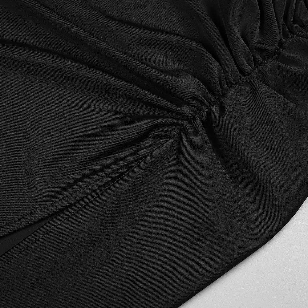 black ruched fabric with smooth slightly glossy texture and fine stitching along gathered seams on long sleeved hollow slit elastic shoulder dress