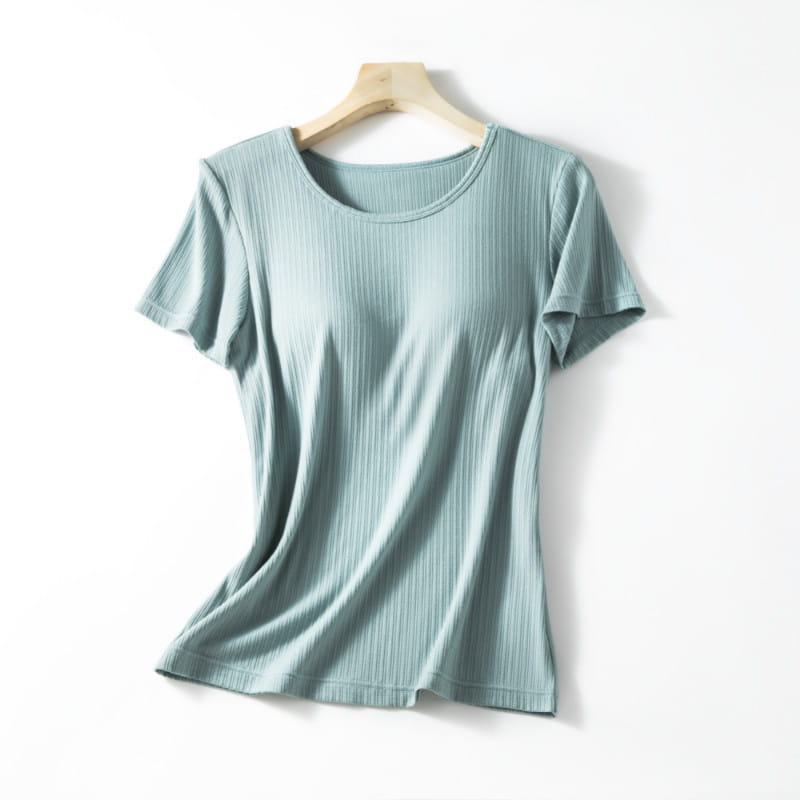 A soft light teal ribbed cotton women’s summerdale loose-fitting padded chest top with short sleeves and a round neckline.