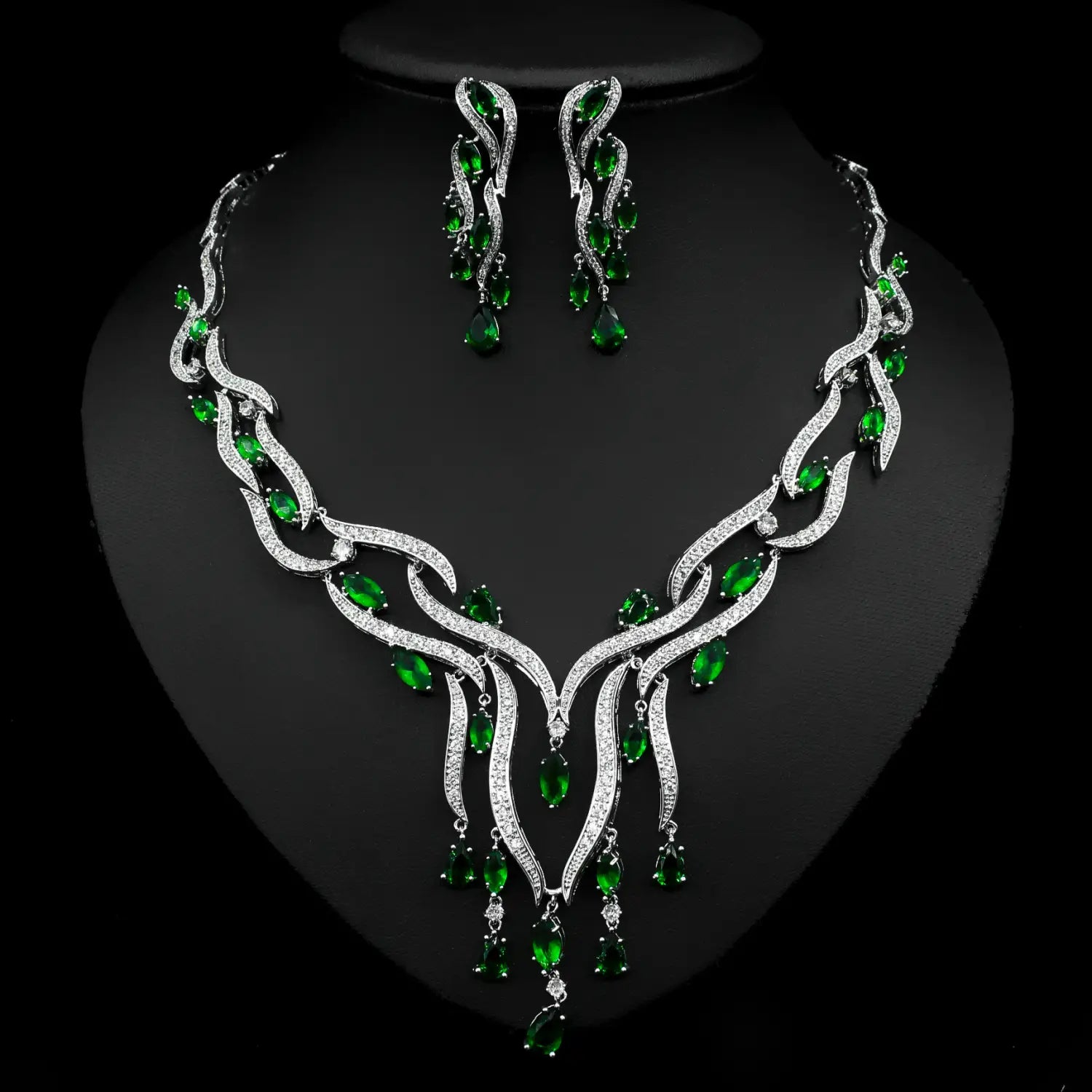 Elegant emerald green crystal jewelry zircon set featuring a flowing leaf-inspired necklace with cascading teardrop stones and matching earrings.