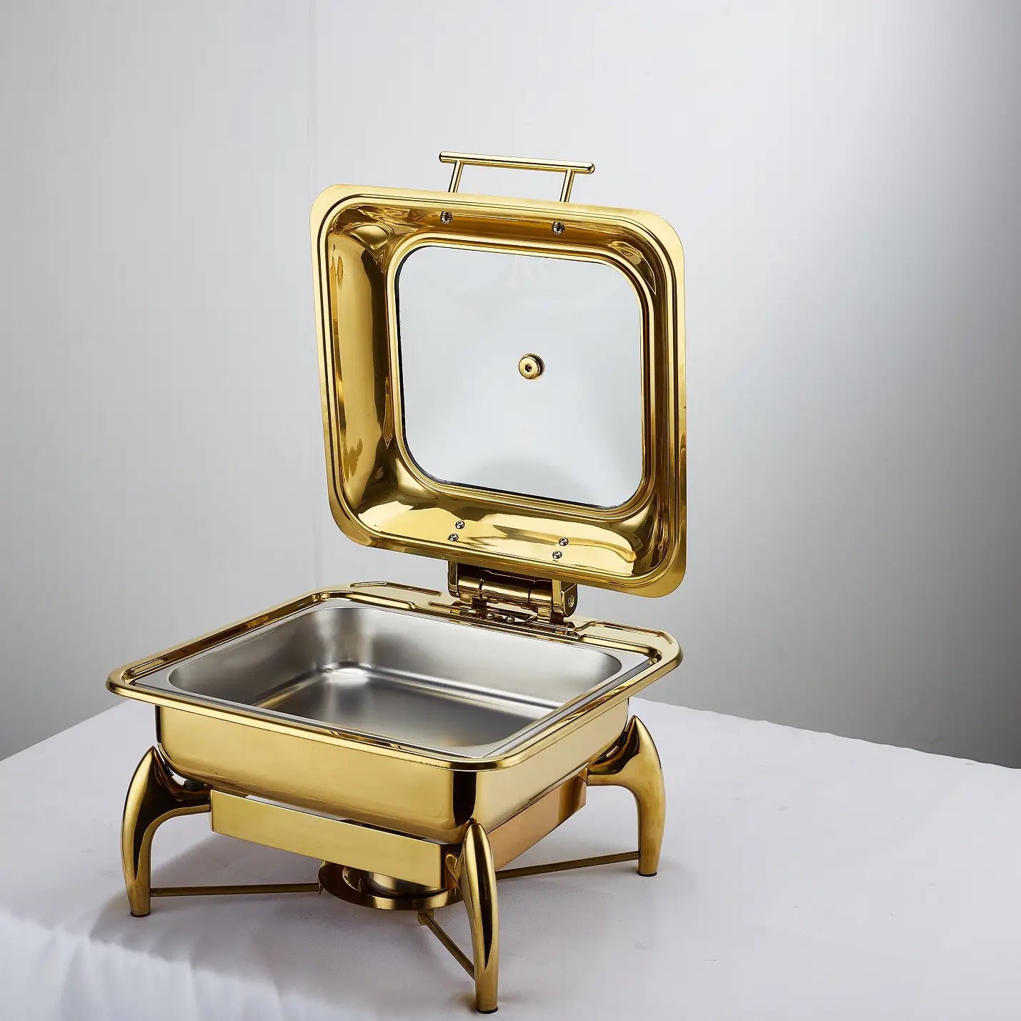 Gold-finished stainless steel buffet stove with hinged glass lid and decorative legs for hotel restaurant bufei use.