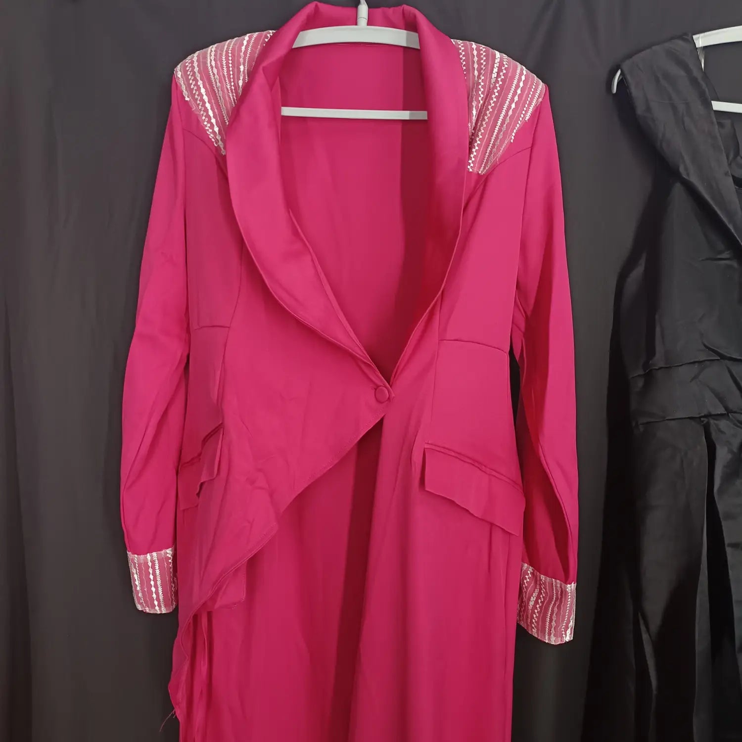 A vibrant rose red suit collar embellished wrap dress featuring a fuchsia blazer with sequined shoulder and cuff accents.