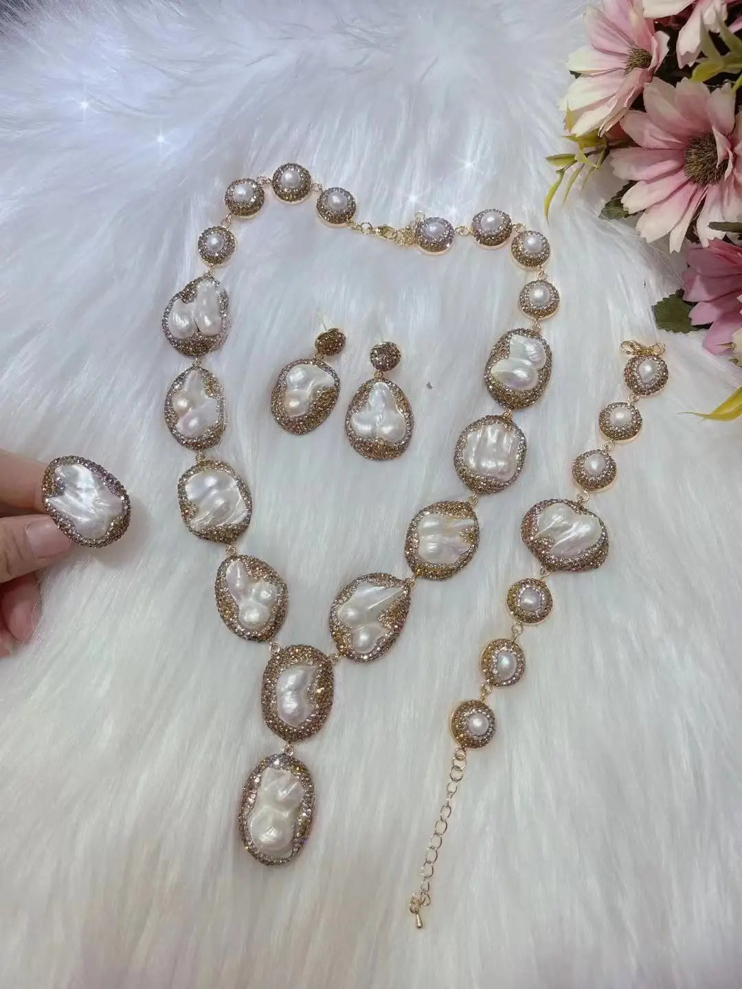 Elegant gold-toned pearl necklace ring suit featuring irregularly shaped white baroque pearls encased in sparkling crystal bezels for bride ornament.