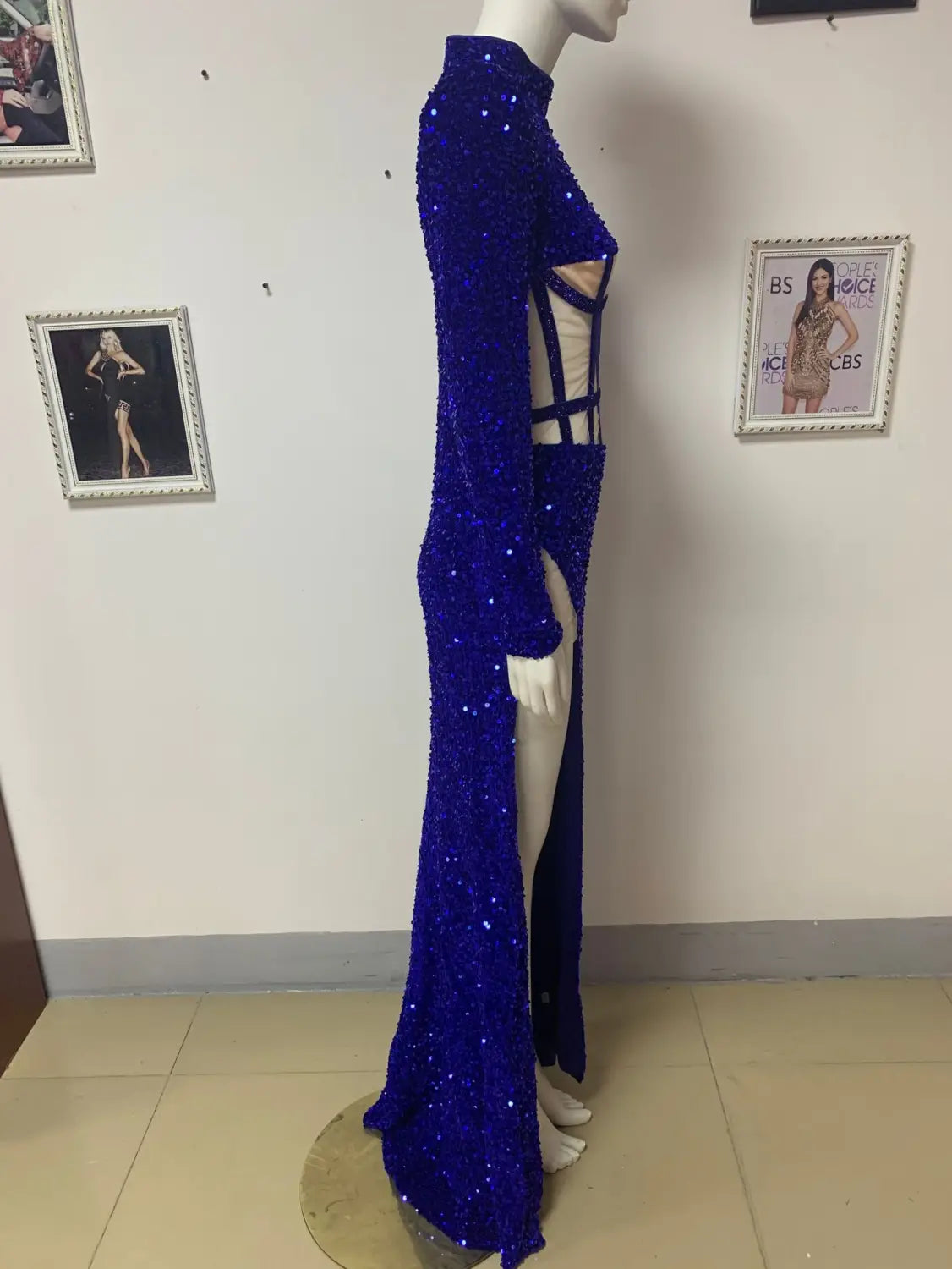 A dazzling royal blue siren ji sequin gown with a high neckline long sleeves and a high slit.