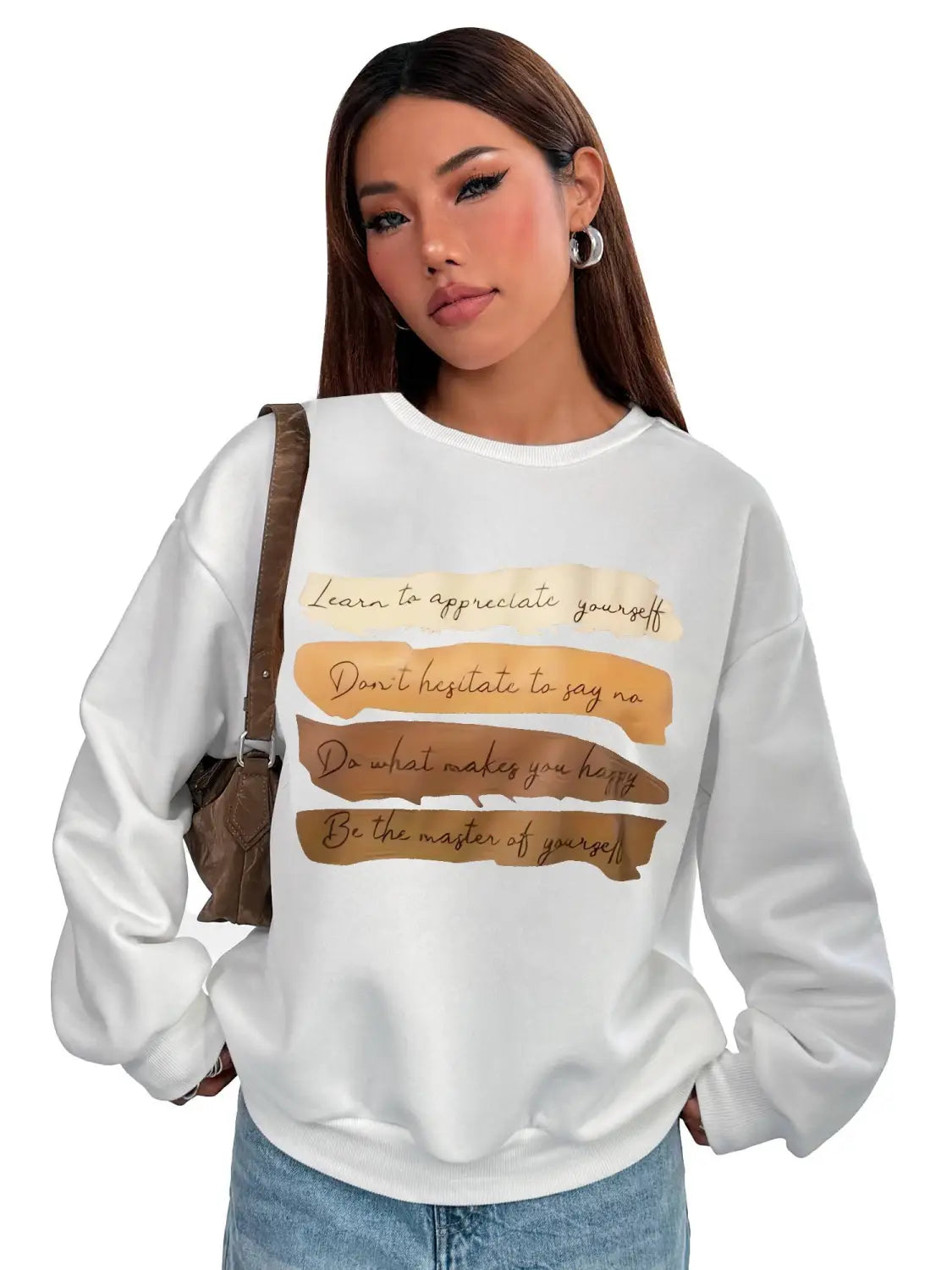 White oversized long sleeve sweatshirt in solid colour featuring motivational quotes in brown and beige tones suitable for daily wear.