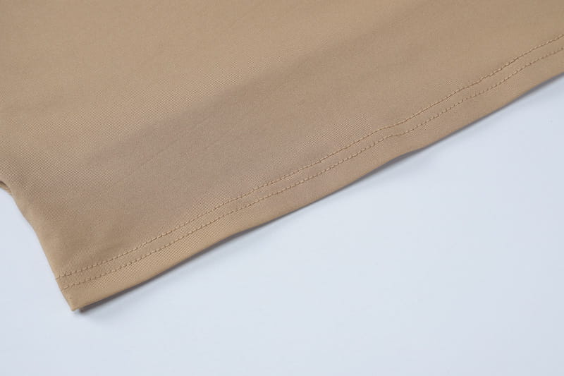 beige solid color fabric with neat parallel stitching along the hem of women tank tops long skirt solid color two piece set
