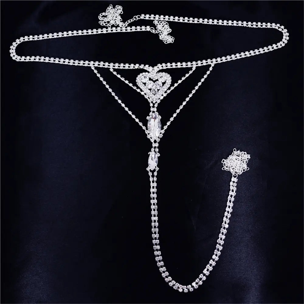 a sparkling silver rhinestone panty body jewelry with a heart rhinestone centerpiece and dangling crystal drops featuring a garter belt
