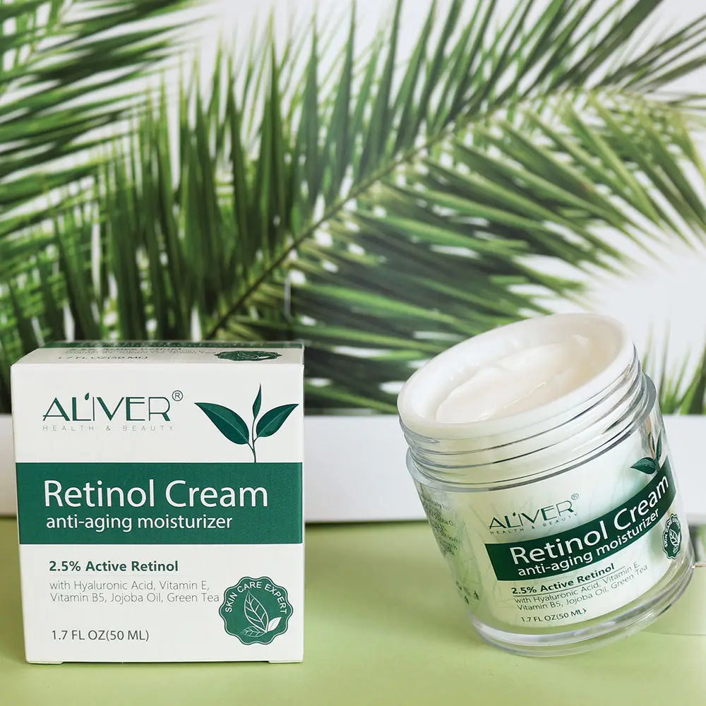 Clear glass jar of 2.5% active retinol cream anti aging moisturizer with white lid and green label alongside its matching box, highlighting retinol cream for anti-aging skincare.
