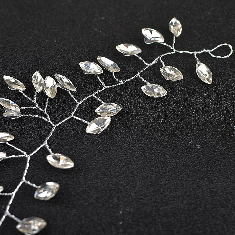 Silver wire horse eye silver flexible chain wedding hair accessory adorned with clear faceted crystal leaves.