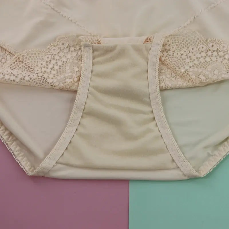 Cream-colored plus size underwire lace trim underwear featuring smooth satin-like fabric and delicate floral embroidery along the waistband.