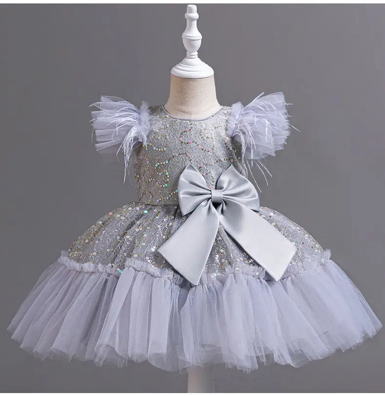 Silver sequined wedding dress tulle skirt summer with feathered shoulder accents and large satin bow at the waist featuring a dress tulle skirt for formal occasions.