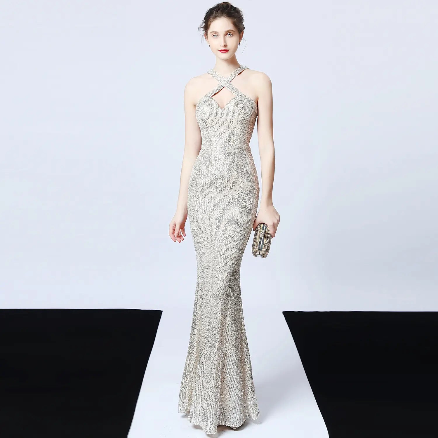 a black sequined mermaid dress made of polyester fiber featuring a shimmering silver sequined halter neckline with crisscross straps and a long skirt length main fabric