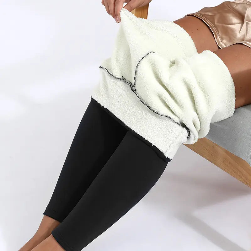 Cream-colored royale essence lux high stretch winter leggings with fleece lining and black trim showcasing a soft, plush texture.