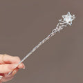 A delicate silver celestial moonstone xingx hairpin with twisted detailing and a central glowing crystal for updo moonstone styles
