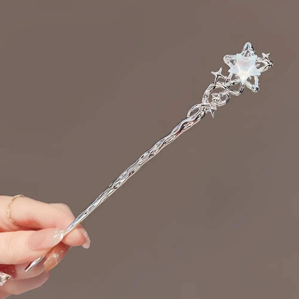 A delicate silver celestial moonstone xingx hairpin with twisted detailing and a central glowing crystal for updo moonstone styles