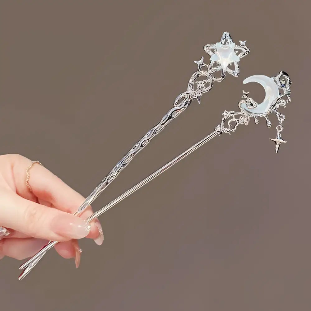 Two silver-toned hairpins with celestial moonstone xingx crescent moon and star filigree designs for elegant updo moonstone styling