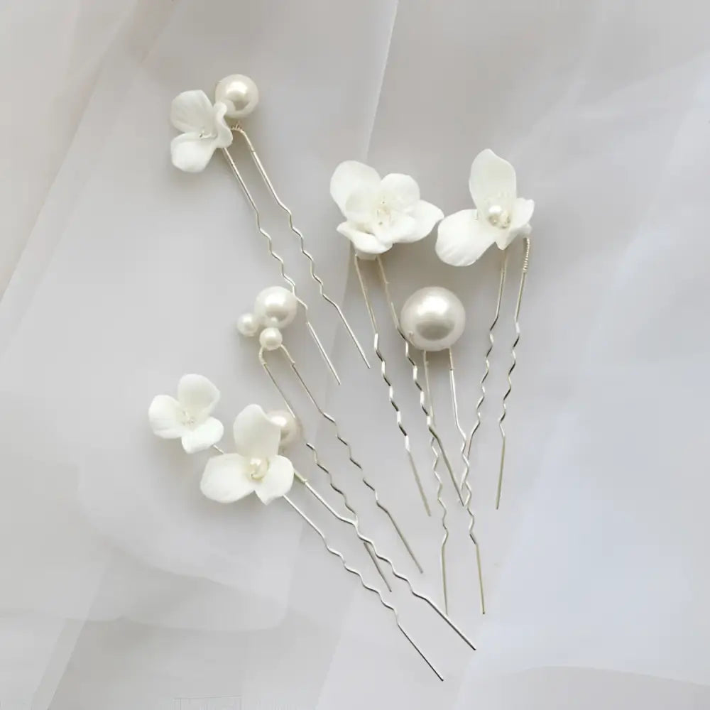 Elegant white floral embellished bridal hairpin featuring delicate white ceramic flowers and pearl embellishments