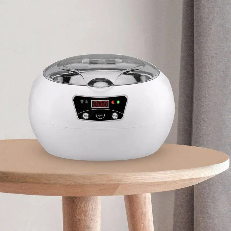 White oval-shaped ceramic ultrasonic cleaning machine with transparent lid and digital display for precise cleaning