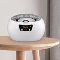 White oval-shaped ceramic ultrasonic cleaning machine with transparent lid and digital display for precise cleaning