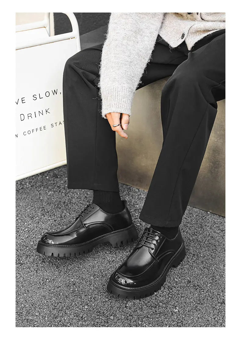 Black patent leather casual leather shoes with red stitching feature lace-up design and thick textured soles.