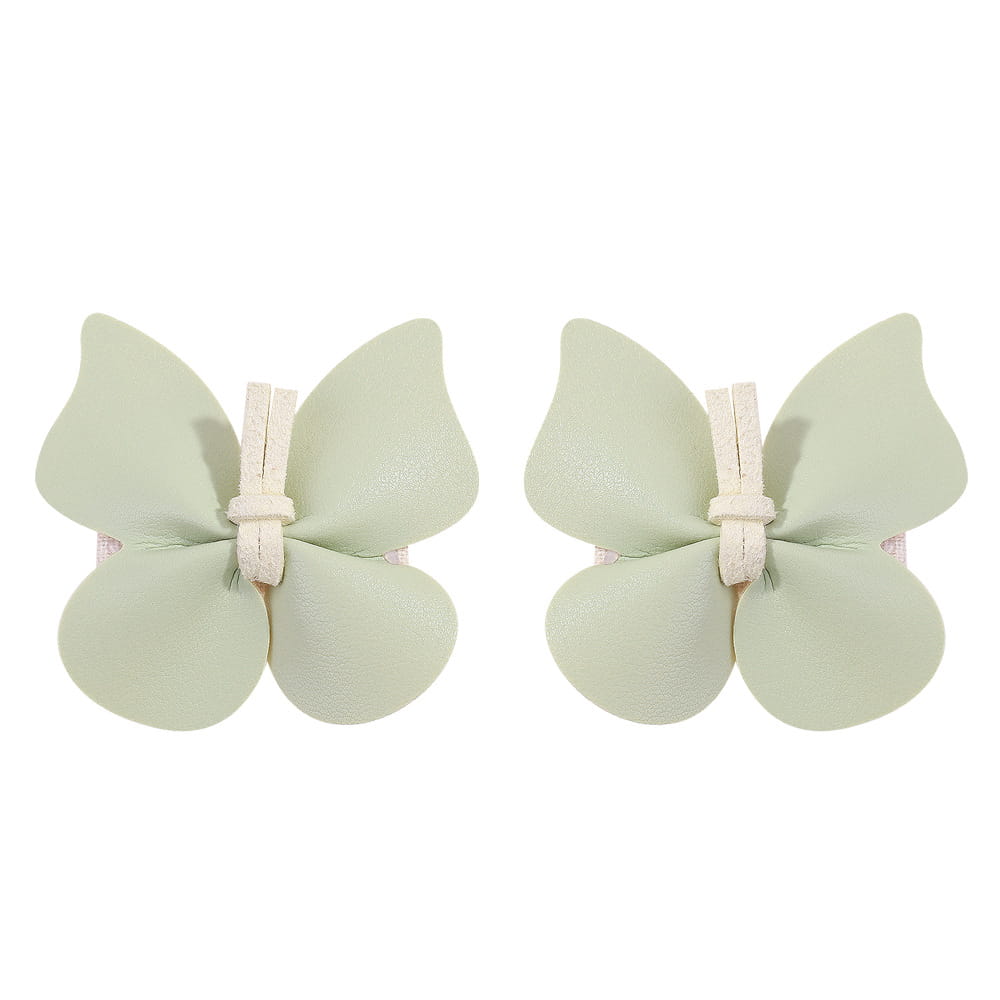 Pair of pale green leather butterfly bag clip children’s barrettes with a soft matte finish and white fabric ties.
