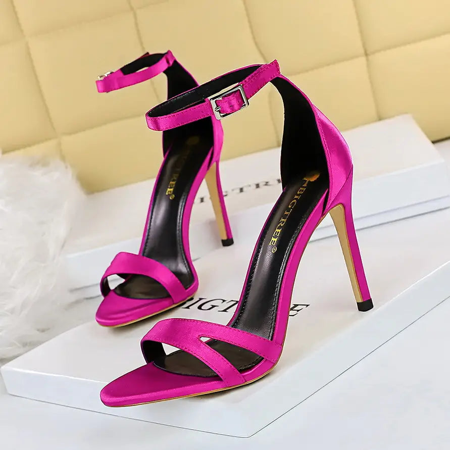 Vibrant fuchsia satin high heel toe sandals featuring a sleek ankle strap with metallic buckle, complementing the black satin high heel toe cutout sandals collection.