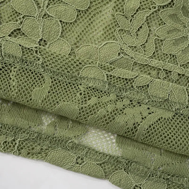olive green lace fabric with intricate leaf and vine patterns used in a sage green lace backless tube featuring sling stitching ruffle and stitching ruffle hip details.