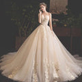 Strapless ivory champagne lace wedding gown with gold lace appliqués and voluminous tulle skirt for pregnant woman