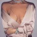 Champagne satin blouse with deep v-neckline long sleeves and rhinestone body jewelry body chain detail