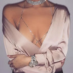 Champagne satin blouse with deep v-neckline long sleeves and rhinestone body jewelry body chain detail