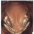 Champagne satin blouse paired with a shimmering gold mesh body chain featuring intricate rhinestone body jewelry embellishments