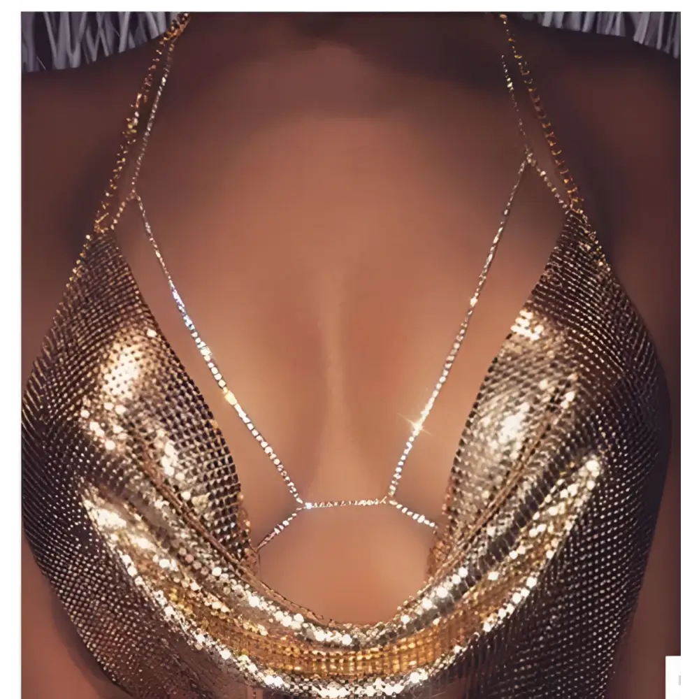 Champagne satin blouse paired with a shimmering gold mesh body chain featuring intricate rhinestone body jewelry embellishments