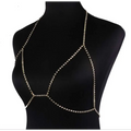 A shimmering gold rhinestone body jewelry chain designed to drape elegantly over the champagne satin blouse