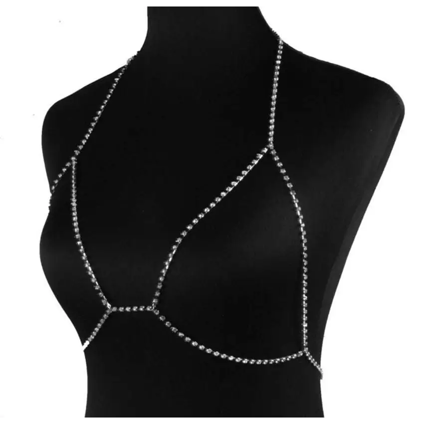 Silver rhinestone body chain harness paired with a champagne satin blouse featuring rhinestone body jewelry accents