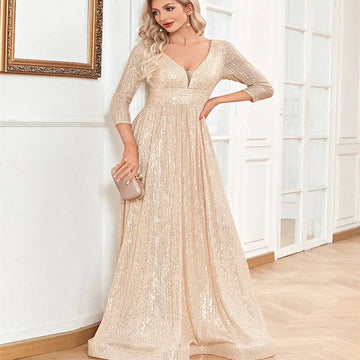 Champagne sequined evening gown with deep v-neckline and three-quarter sleeves for formal party wear