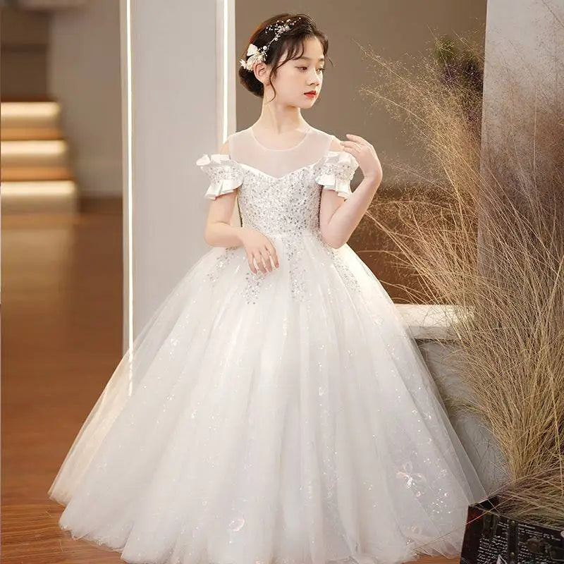 A white off-the-shoulder champagne sequined spandex princess dress with sparkling embellishments and girls tulle tutu