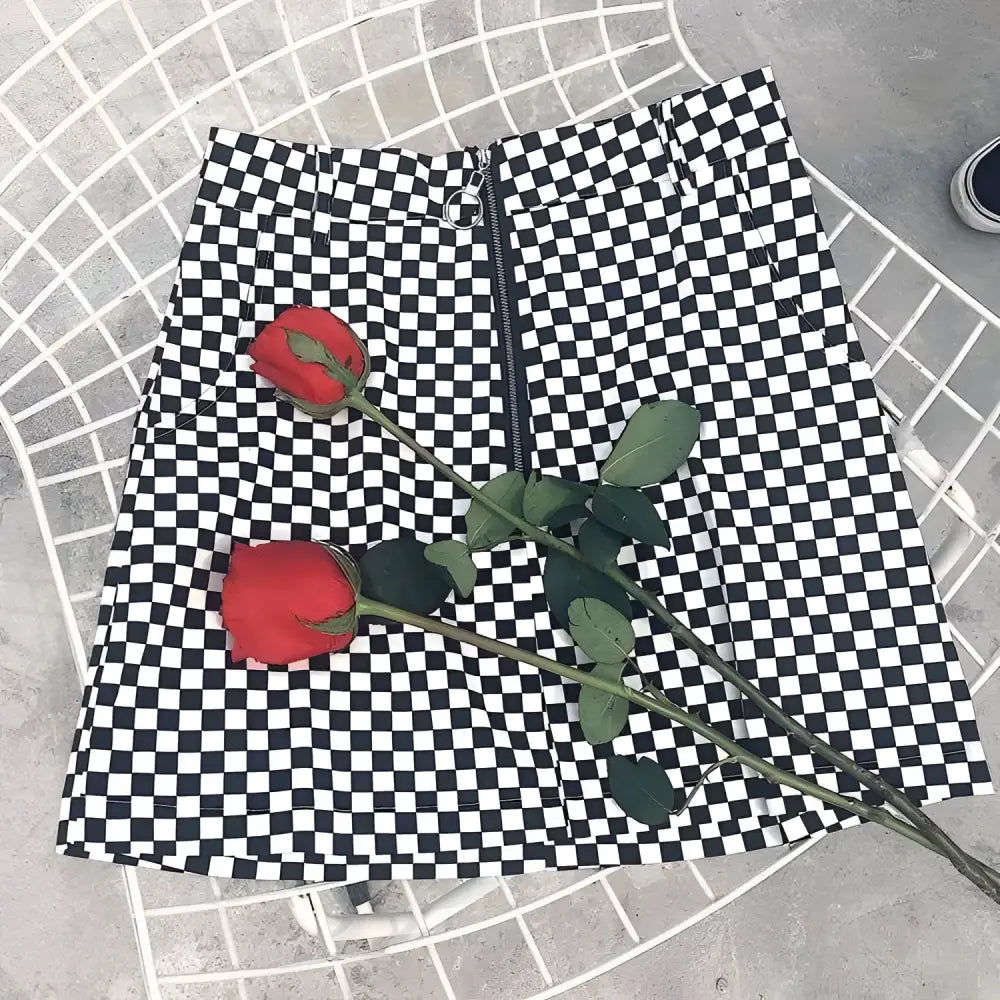 Black and white checkered mini skirt with front zipper closure featuring variable mso-font-signature design