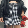 Black and white checkered mini skirt with front zipper and silver ring detail featuring variable mso-font-signature design
