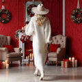 A plush off-white fleece chic winter party fleece maxi dress with long sleeves and flowing silhouette worn by a woman