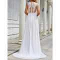Back view of a flowing white chiffon lace trailing wedding large swing dress with intricate lace and sheer mesh panel