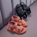 A pair of peach breathable casual shoes for children with adjustable velcro straps and a soft rubber sole