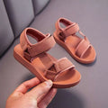 A pair of children’s peach breathable casual shoes with cushioned sole and adjustable velcro straps for school wear