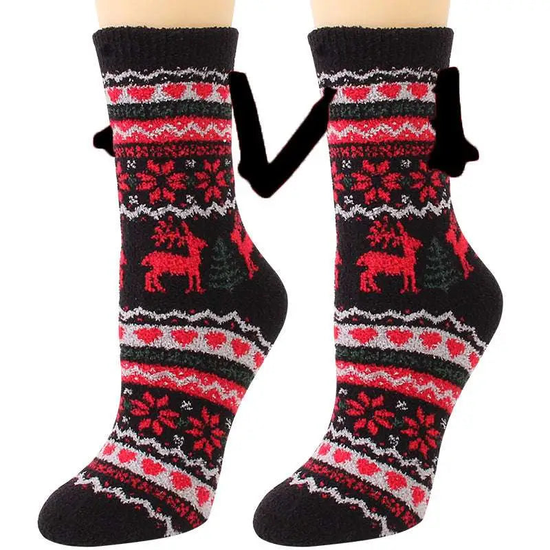 Black knit warm slipper socks with red and white festive reindeer patterns and magnetic suction couple feature