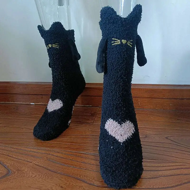 Black fuzzy cat-themed warm slipper socks with embroidered yellow whiskers and pink heart for magnetic suction couple use