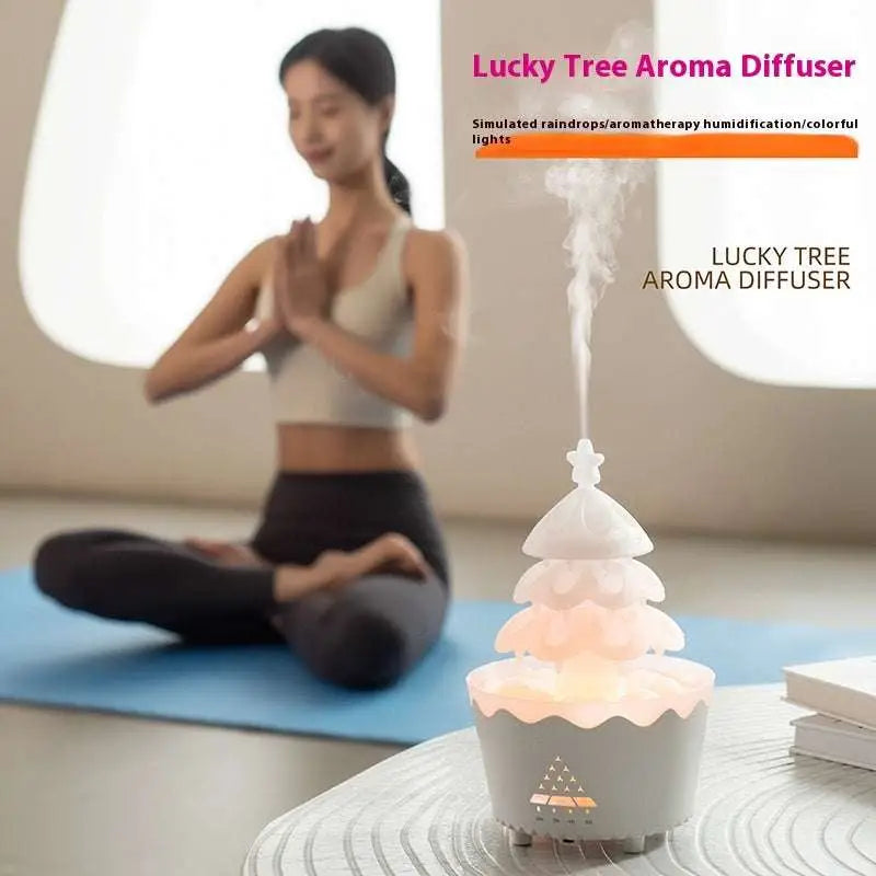 White tree-shaped christmas tree essential oil aroma diffuser humidifier with tiered layers and soft glowing base