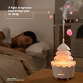 White tiered christmas tree essential oil aroma diffuser humidifier emitting soft glow with pink rose petals